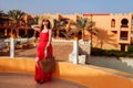 Young woman walking on hotel territory. Summer vacation in Egypt. Stylish fashionable look Royalty Free Stock Photo