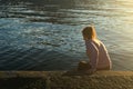 Young woman walking in the lake water at sunset. Life style concept Royalty Free Stock Photo