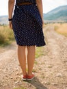 Young woman walking on a long deserted road Royalty Free Stock Photo