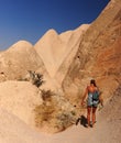 Young woman walking in mountains. Cappadocia valley