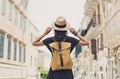 Young woman walking in old town during vacation, cheerful student girl traveling abroad in summer, travel and enjoying life