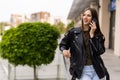 Young woman walking outdoors, talking on mobile phone Royalty Free Stock Photo