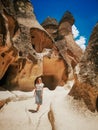 Young woman walking among Pasabag valley in Cappadocia. Fashion in desert.