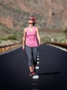 Young woman walking on the road in Teide volcano crater