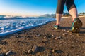 Young Woman walking on Sand Beach along Sea Surf at Morning Shoes Close Up Royalty Free Stock Photo