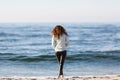 Young woman walking on the seacoast Royalty Free Stock Photo