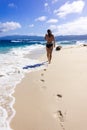 Young woman walking on the seaside on the sand