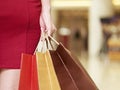 Young woman walking with shopping bags in mall Royalty Free Stock Photo