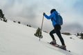 Young woman walking with snow rackets in high mountain