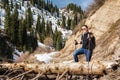 Young woman with walking sticks overcomes an obstacle in mountains Royalty Free Stock Photo