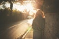 Young woman walking into sunset in city Royalty Free Stock Photo