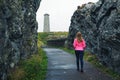 Young woman walking towards Wicklow Head Lighthouse in Ireland Royalty Free Stock Photo