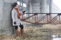 Young woman walking under the bridge