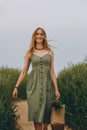 Young woman walking in a wheat field, enjoys life and summer. Green Wheat field. Healthy lifestyle Concept Royalty Free Stock Photo