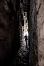 Young Woman Walks Alone Through Spooky Narrow Abandoned Alley In The Night