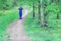 A young woman walks along a path in a spring Park Royalty Free Stock Photo