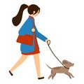 A young woman walks with a dog on a leash. Girl in a coat with a bag walking the dog. Royalty Free Stock Photo