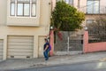 A young woman walks down one of the slope of Lombardt Street in San Francisco, California, USA
