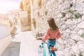 Young woman walks with her bicycle through the streets of an old town Royalty Free Stock Photo