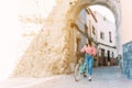 Young woman walks with her bicycle through the streets of an old town Royalty Free Stock Photo