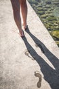 Woman walks and leaves wet footprint.