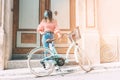 Young woman walks with mask, with her bicycle through the streets of an old town Royalty Free Stock Photo