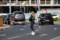 Young woman walks in the middle of the road