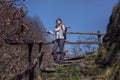 A young woman walks in the nature wearing a face mask due to a virus