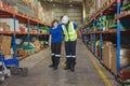 young woman warehouse worker accident leg injury slip and fall ankle sprain friend help support Royalty Free Stock Photo