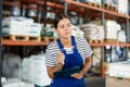 Young woman warehouse worker checking documents Royalty Free Stock Photo