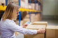 Woman warehouse worker or supervisor with smartphone. Royalty Free Stock Photo