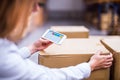 Woman warehouse worker or supervisor with smartphone. Royalty Free Stock Photo