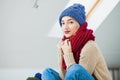 Young woman in warm hand knitted hat at home Royalty Free Stock Photo