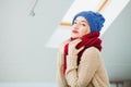 Young woman in warm hand knitted hat at home. Royalty Free Stock Photo