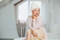 Young woman in warm hand knitted hat at home. Royalty Free Stock Photo