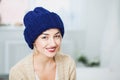 Young woman in warm hand knitted hat at home Royalty Free Stock Photo
