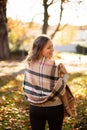 Young woman in warm scarft in the forest