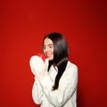 Young woman in warm sweater with cup of hot drink on background Royalty Free Stock Photo