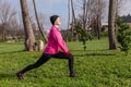 Young woman warming up and stretching before running