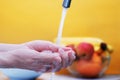 young woman washes her hands