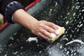 Young woman washing a car