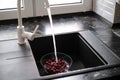 Young woman washing cherries at home Royalty Free Stock Photo