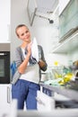 Young woman washing dishes in her modern kitchen Royalty Free Stock Photo