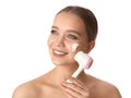 Young woman washing face with brush and cleansing foam on white. Cosmetic products Royalty Free Stock Photo