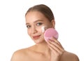 Young woman washing face with brush and cleansing foam on white. Cosmetic products Royalty Free Stock Photo