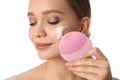 Young woman washing face with brush and cleansing foam on white background. Cosmetic products Royalty Free Stock Photo