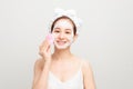 Young woman washing face with brush and cleansing foam on white background. Cosmetic products Royalty Free Stock Photo