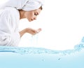 Young woman washing face with clean water.