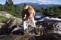 Young woman washing face in river Royalty Free Stock Photo