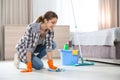 Young woman washing floor with rag and detergent in bedroom. Cleaning Royalty Free Stock Photo